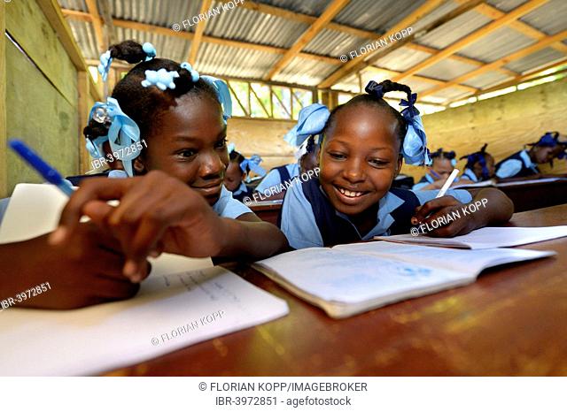 Two girls writing in a notebook, school for earthquake refugees, Fort National, Port-au-Prince, Haiti