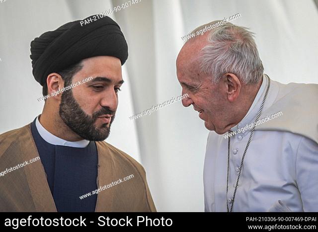 06 March 2021, Iraq, Nasiriyah: Pope Francis (R) speaks with an Iraqi cleric as they attend an interreligious meeting in the Sumerian city-state Ur