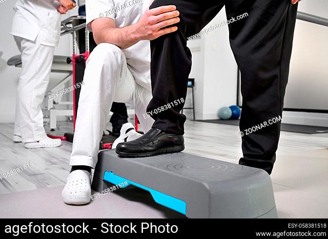 Senior Patient and physical therapist in rehabilitation walking exercises. High quality photo