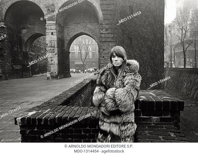 Francoise Hardy wearing a fur in piazza Sant'Ambrogio. French singer and actress Francoise Hardy posing in front of the 'Pusterla dei Fabbri' in piazza...