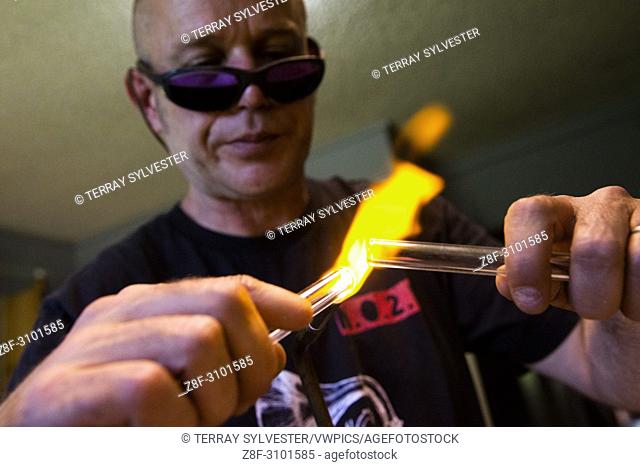 Craig Graffius, owner of EcoGlass Straws, makes glass drinking straws in his workshop on July 5, Hood River, Oregon, United States