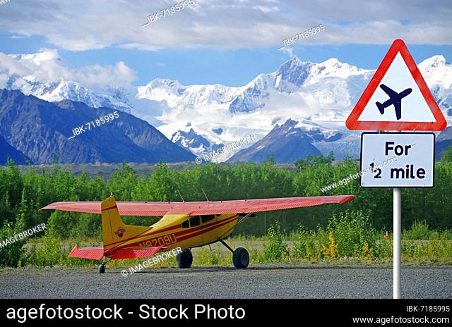 Traffic sign warning of aircraft, small plane in the mountains, glacier, Alaska, USA, North America