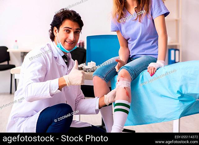 Leg injured young woman visiting male doctor