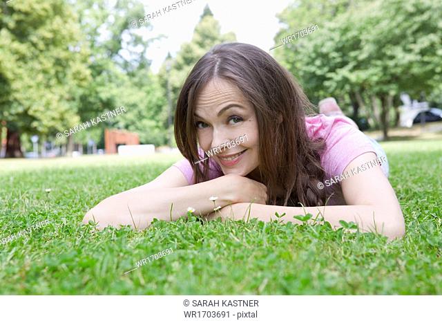Woman lying on a meadow