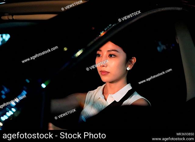 The young woman driving at night