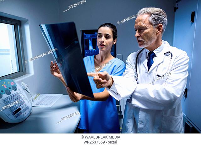 Doctor and nurse examining a x-ray