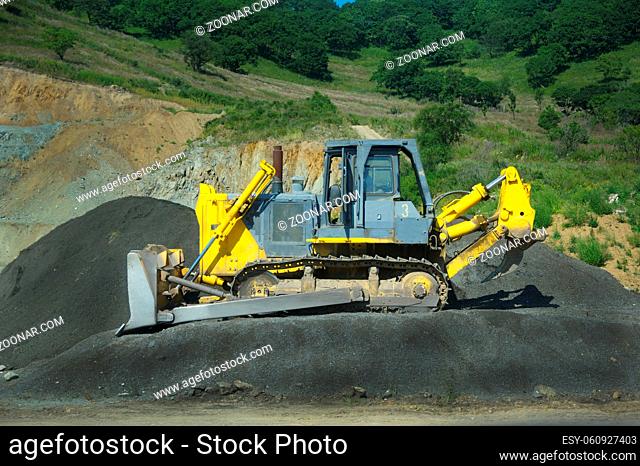 picture of a big yellow bulldozer at work-site