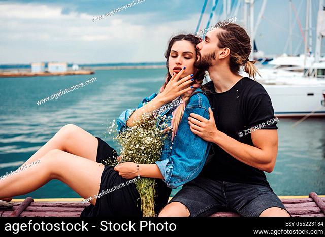 Guy and girl on pier posing on camera