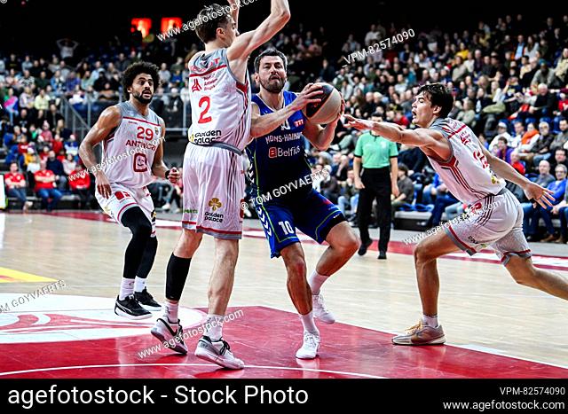 Antwerp's Jean-Marc Mwema, Antwerp's Keevan Veinot and Mons' Maxime Depuydt pictured in action during a basketball match between Antwerp Giants and Mons Hainaut