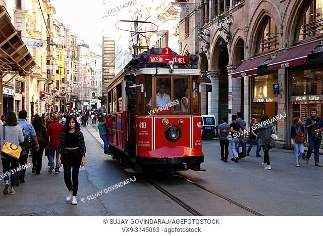Istanbul, Turkey - June 10, 2016: Passengers travelling on old tramway and crowd in a busy street of Istanbul