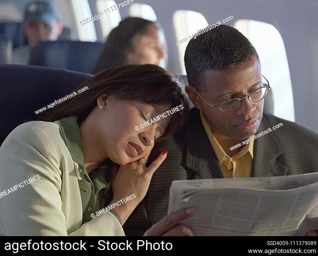 Mature couple relaxing on airplane