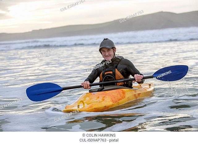 Mature man sea kayaking