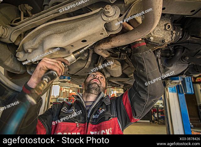 MILAN, ITALY: Mechanic repairs the car