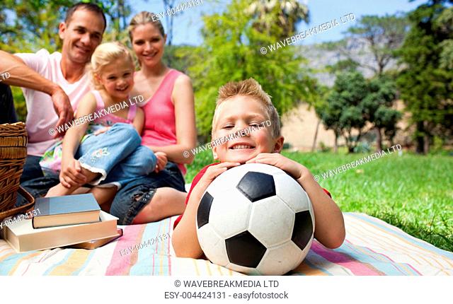 Smiling boy holding a soccer ball