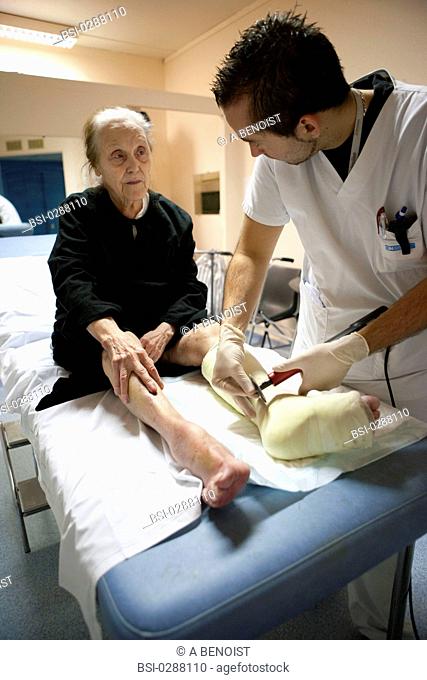 Photo essay from La Croix Saint-Simon Hospital, Paris, France. Department of orthopedics. Physical therapist with a patient who fractured her ankle