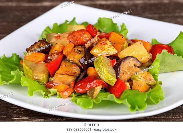 Roasted vegetables on a white plate , close up