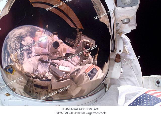 Astronaut Michael E. Fossum, STS-121 mission specialist, used a digital still camera to expose a photo of his helmet visor during today's session of...