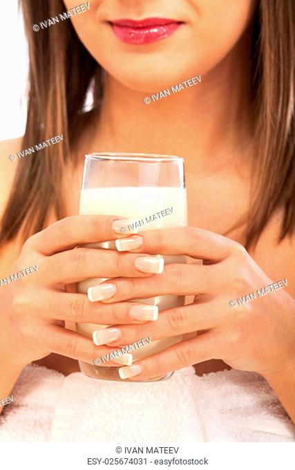 Woman drinking milk looking at camera, isolated on white background with copy space