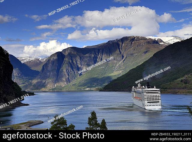 View of the Cruise ship MSC Orchestra, leaving the harbour at the town of Flam, where the famous Flam Railway starts from, Aurlandsfjorden Fjord