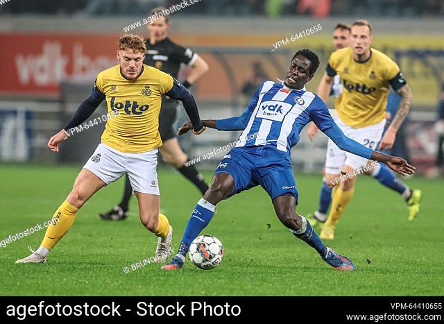 Union's Yorbe Vertessen and Gent's Joseph Okumu fight for the ball during a soccer match between KAA Gent and Royale Union Saint-Gilloise