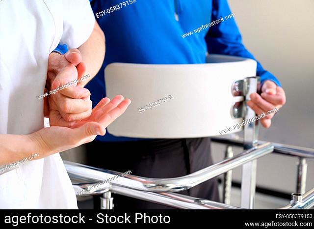Physiotherapist assisting a patient with Amyotrophic Lateral Sclerosis. High quality photo