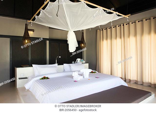 Bed with a mosquito net in a luxury bungalow, The Sevenseas Resort, Ko Kradan, Koh Kradan, Trang, Thailand, Southeast Asia, Asia