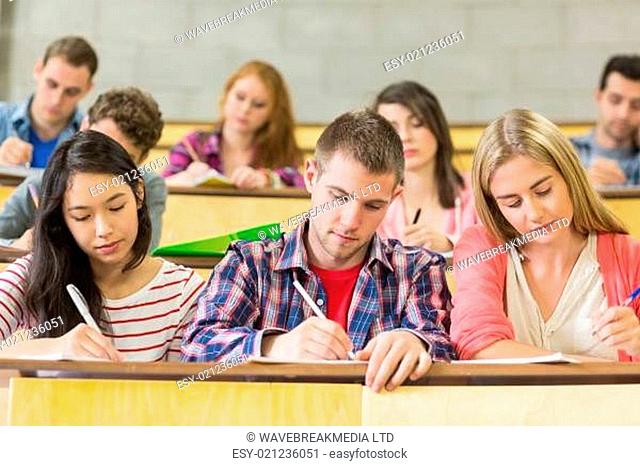 Young students writing notes in the classroom
