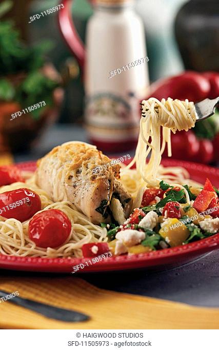 Stuffed turkey roulade on pasta with vegetables