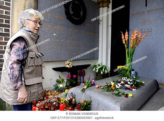 Russian poetess and translator Natalya Gorbanevskaya gives flowers on the grave of former Czech President Vaclav Havel at the Vinohrady Cemetery in Prague