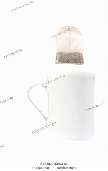 Teebeutel und eine weiße Tasse isoliert auf weißem Hintergrund