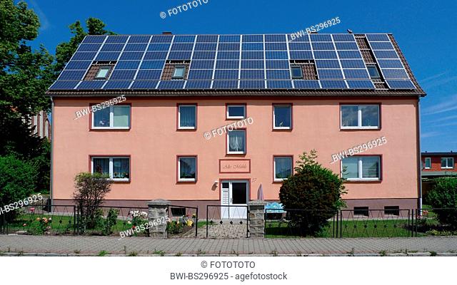 tenement building with the hole roof covered with solar panels