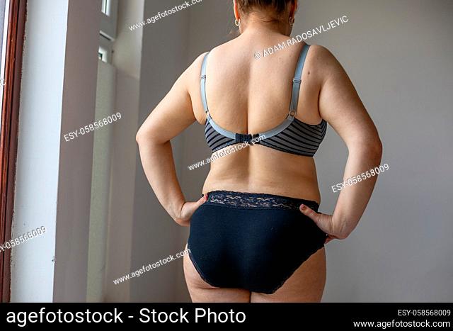 Woman Real Body Plus size model in lingerie posign and showing fat on back, imperfect nonideal