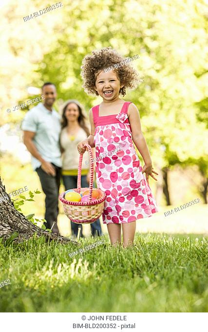 Mixed race girl on Easter egg hunt