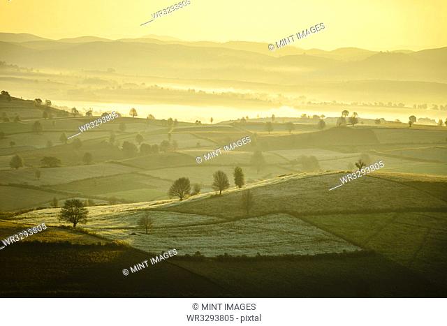 Sunrise over farmland in rural landscape