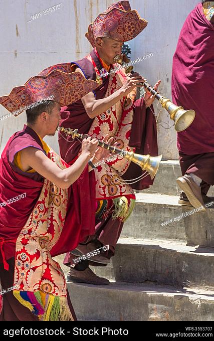 Buddhist Monks playing horns on the Korzok Gompa, during the Korzok Gustor, Lake Tsomoriri, (Ladakh) Jammu & Kashmir, India