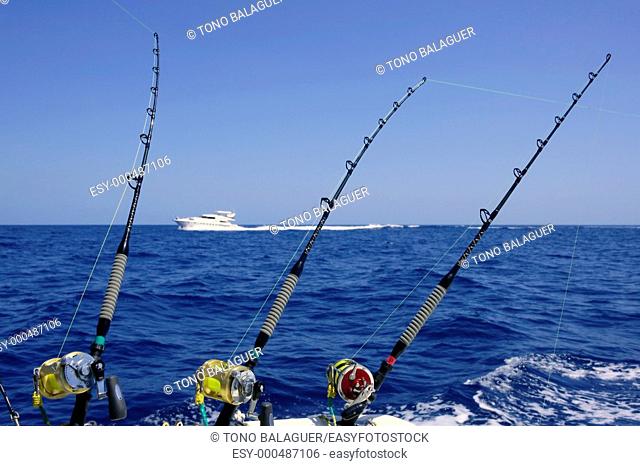 Blue sea and sky in a big game tuna fishing day rods and reels on boat
