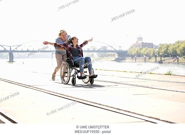 Grandmother with her granddaughter sitting in wheelchair