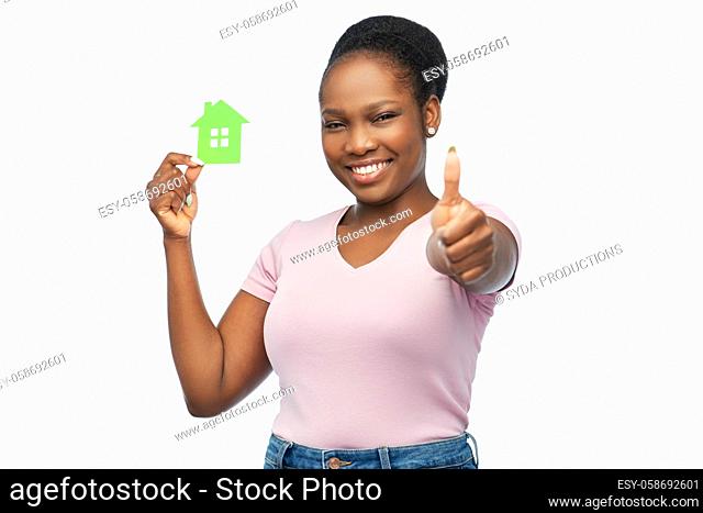 smiling african american woman holding green house