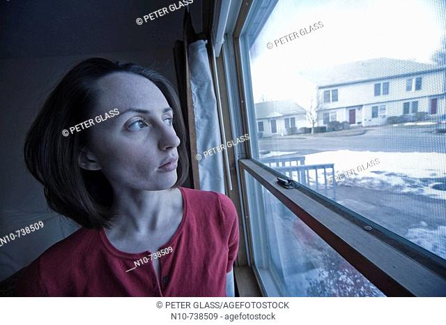 Young woman posing in front of a window