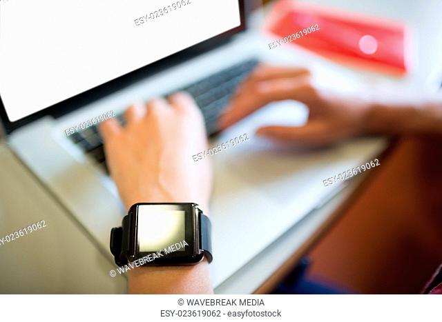Cropped image of female student using laptop