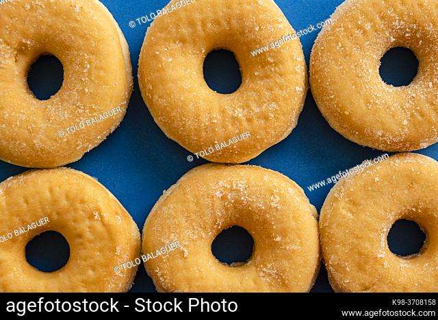 six doughnuts on blue background