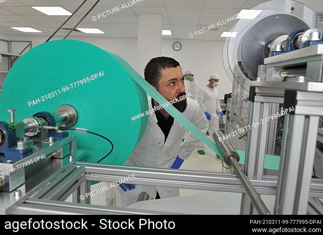 03 March 2021, Berlin, Marzahn: Nico Feichtinger, company director of Typ IIR GmbH, controls the production of the three-layer surgical masks in his plant in...