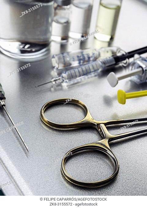 Surgical scissors along with several roads to be injected into a hospital