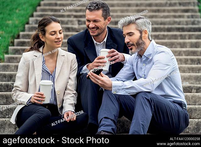 Businesspeople relaxing in public park
