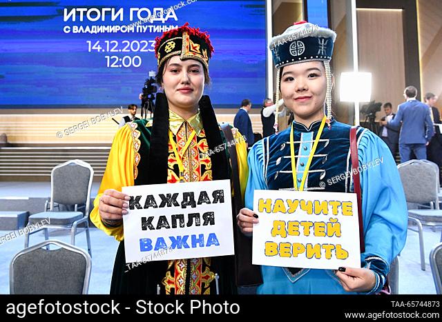 RUSSIA, MOSCOW - DECEMBER 14, 2023: Journalists in traditional costumes hold signs with messages reading ""Every Drop Counts"" and ""Teach Children To Believe""...
