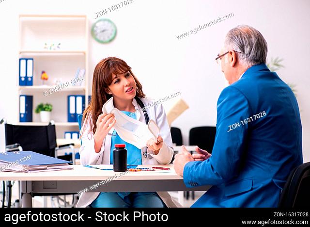 Old businessman visiting young doctor