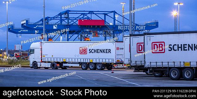 PRODUCTION - 21 November 2023, Mecklenburg-Western Pomerania, Rostock: Trailers from the logistics company DB Schenker are parked on the site of the logistics...