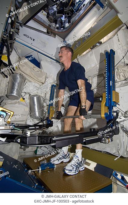 NASA astronaut Dan Burbank, Expedition 30 commander, exercises using the advanced Resistive Exercise Device (aRED) in the Tranquility node of the International...