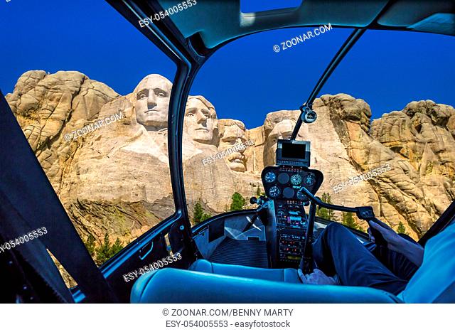 Helicopter interior flying on Mount Rushmore National Memorial of United States of America in South Dakota. US historical presidents: Washington, Jefferson