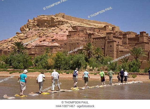 Tourists crossing the river at Ait Ben Haddou Kasbah, Ouarzazate, Morocco